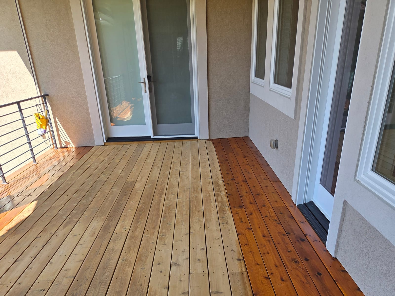Shiplap wall paneling showing the transition from freshly stained boards to bare unstained wood
