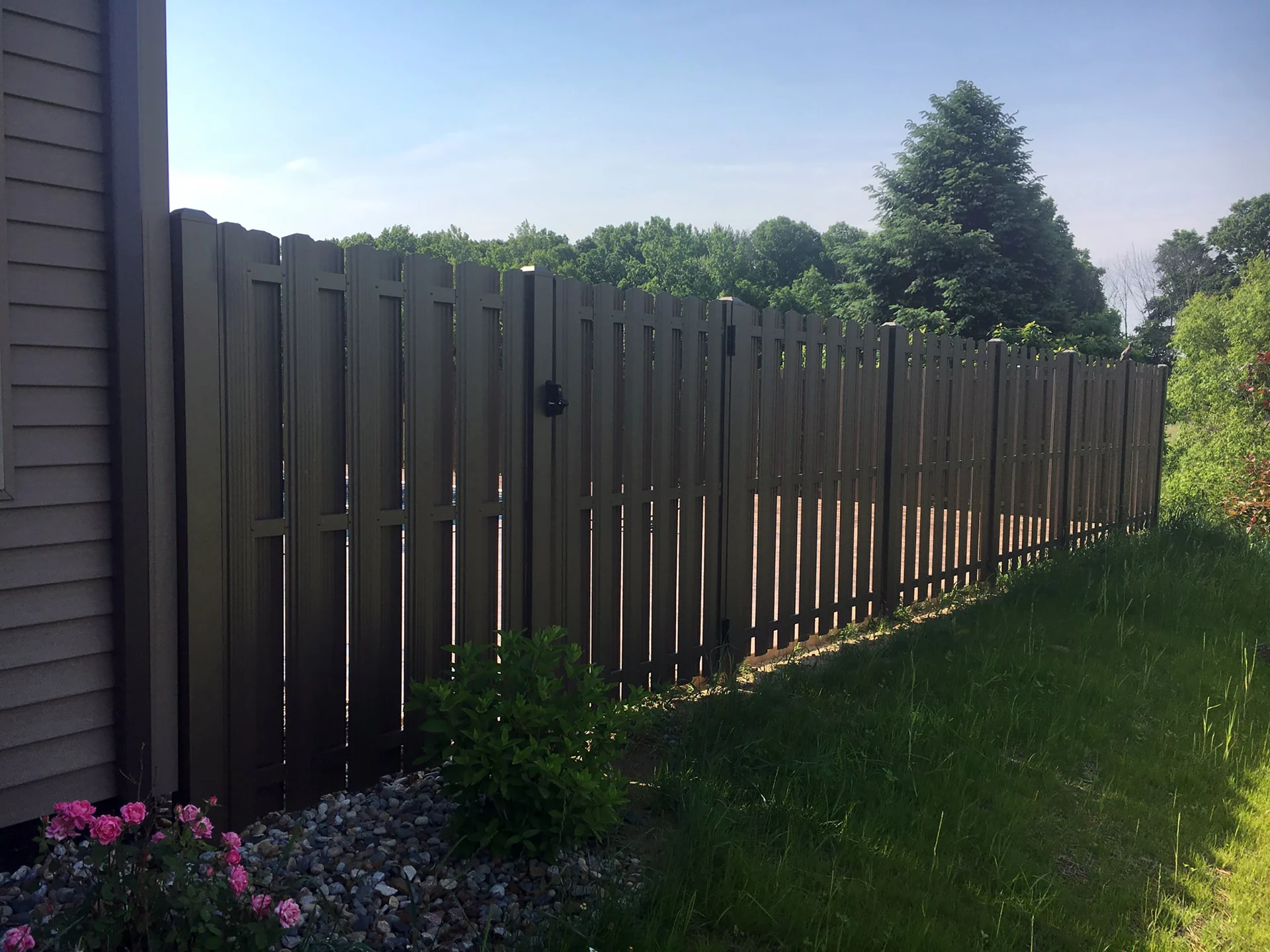 Black noncombustible steel fence panel installed against a home in Boulder County