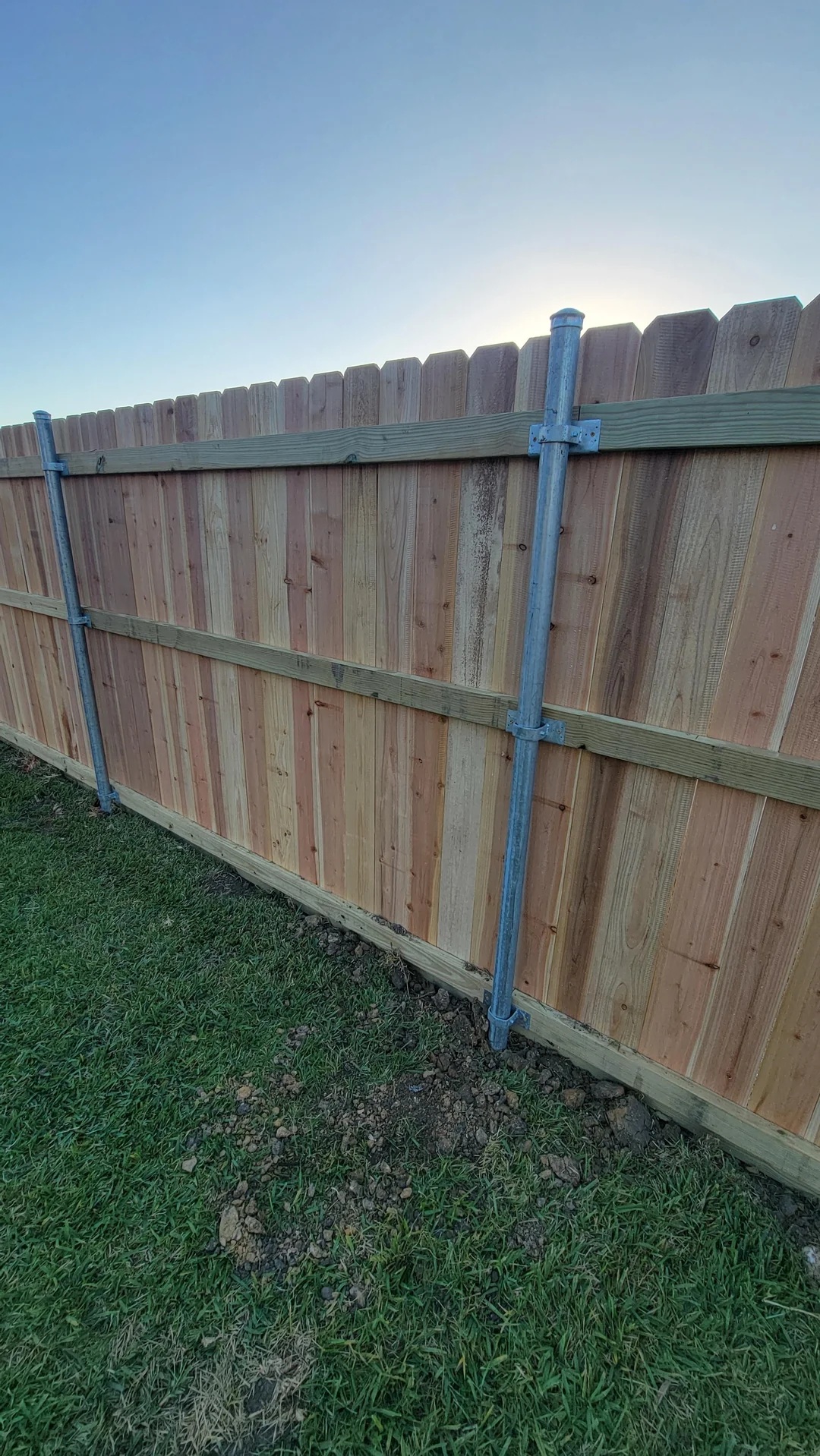King Plus cedar fence with layered wide boards and shadow-line profile